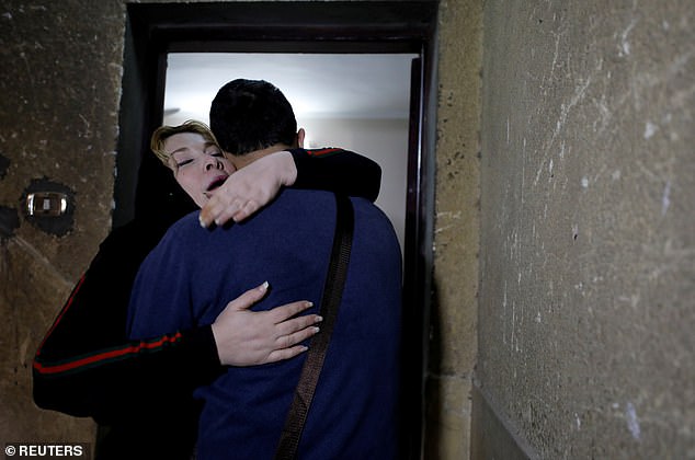 The pair embraced in the stairwell - on their first meeting for 20 years