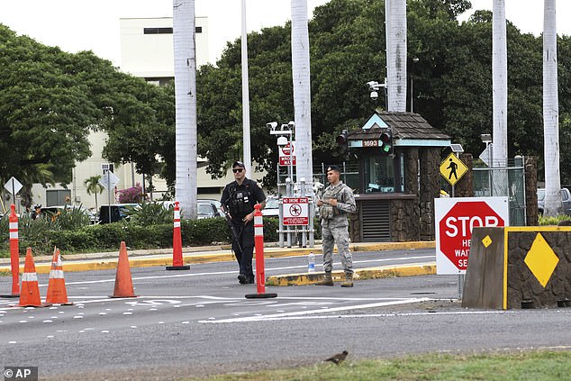 Security stand outside the main gate at Joint Base Pearl Harbor. A U.S. sailor shot three civilian Department of Defense employees at the Pearl Harbor shipyard Wednesday before taking his own life, the military said