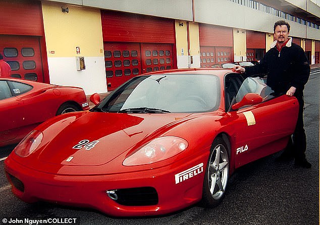 The Ferrari-driving car salesman at an event in 2002. He had previously sent out a Christmas card posing with models and the car