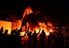 Iraqi forces shoot dead 13 people after anti-government protesters set fire to Iranian consulate