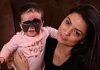 Mother cuddles up to her baby daughter with ‘Batman mask’ birth mark