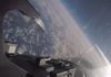 F16 jet flies through another aircraft’s contrails while participating in air-to-air exercise